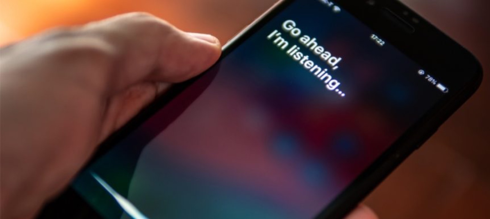 Voice assistant on a phone screen reading Go ahead, I'm listening