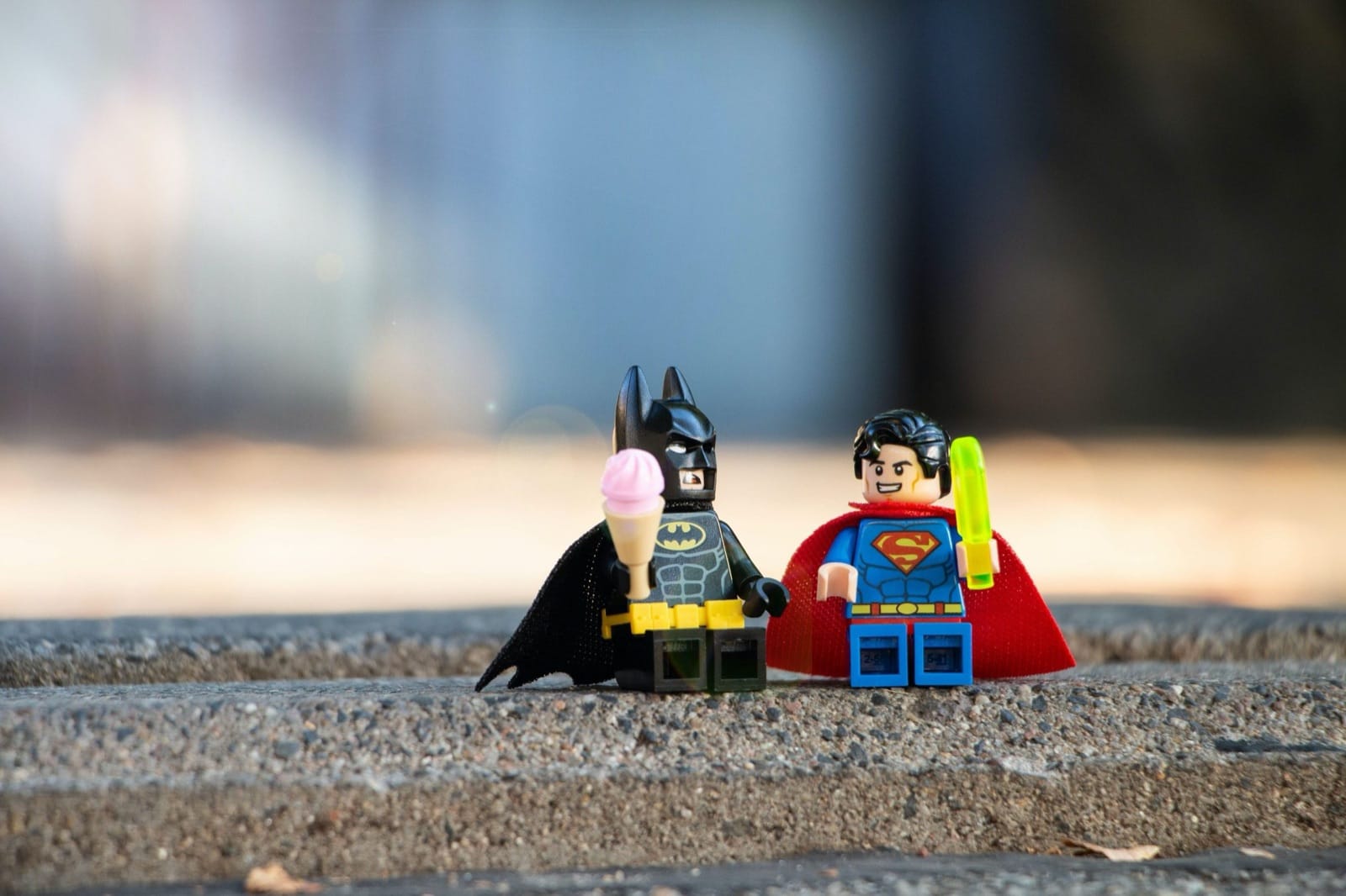 Lego Batman and Superman figures with ice creams
