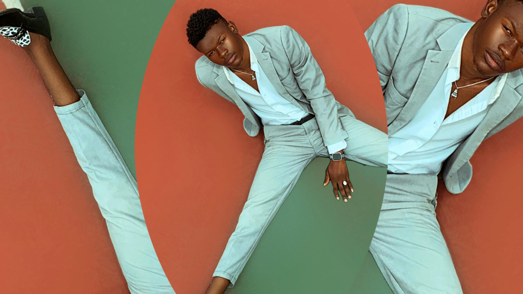 Fashion portrait of a person wearing a light blue suit.